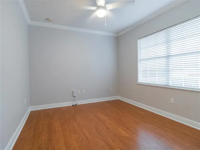 wooden floor in an empty room with a window