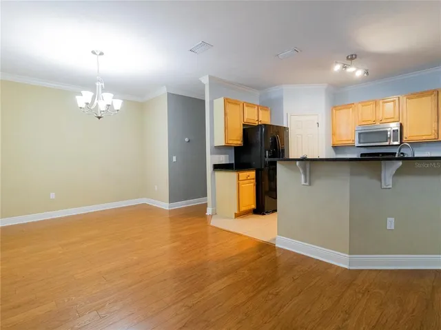 a view of a kitchen with microwave and cabinets
