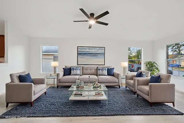 a living room with furniture or couch and a ceiling fan