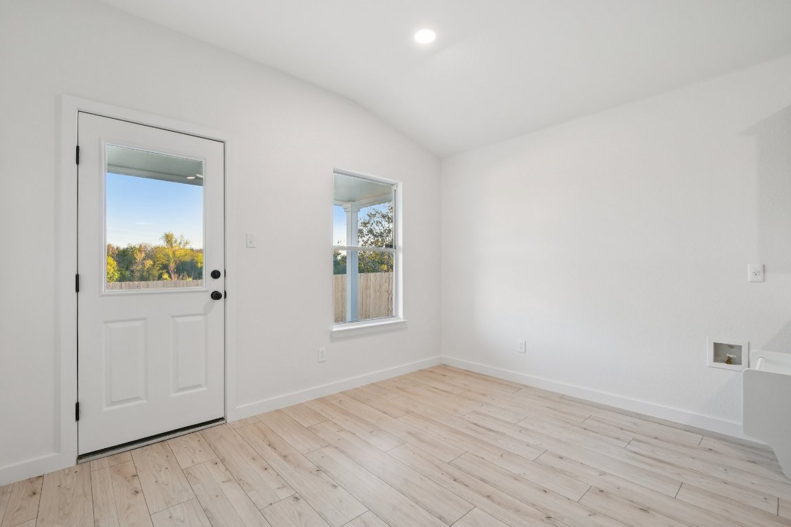 17921 Basket Flower Bend Elgin, TX 78621 - Photo 21 of 40 an empty room with wooden floor and a window