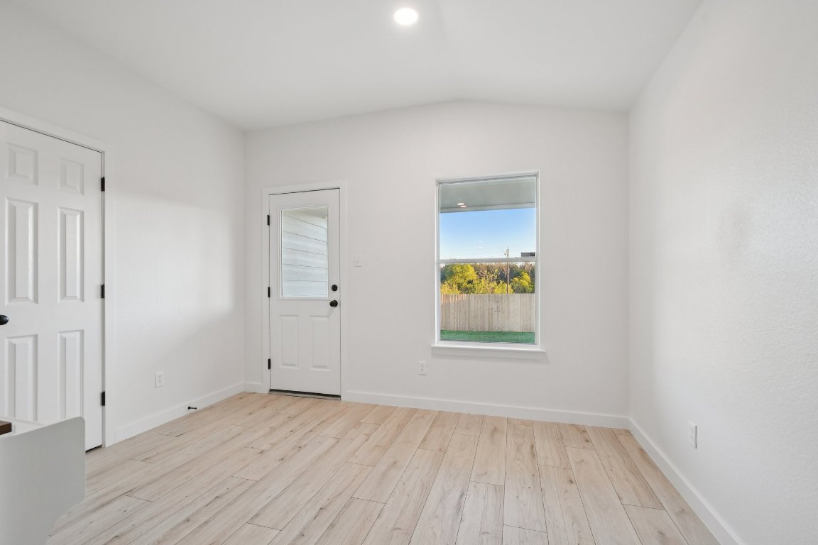 17921 Basket Flower Bend Elgin, TX 78621 - Photo 22 of 40 an empty room with a window and wooden floor
