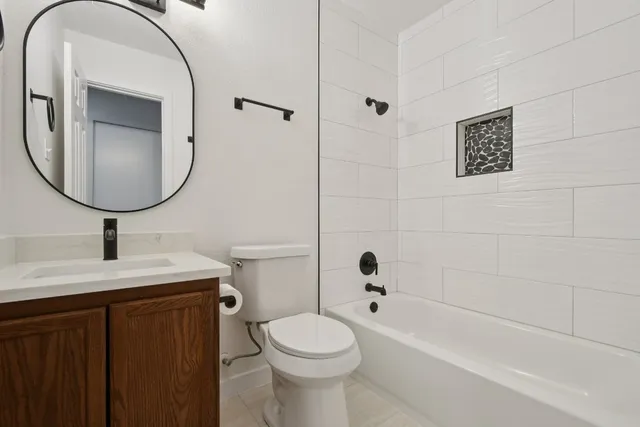 a bathroom with a sink a toilet and a mirror