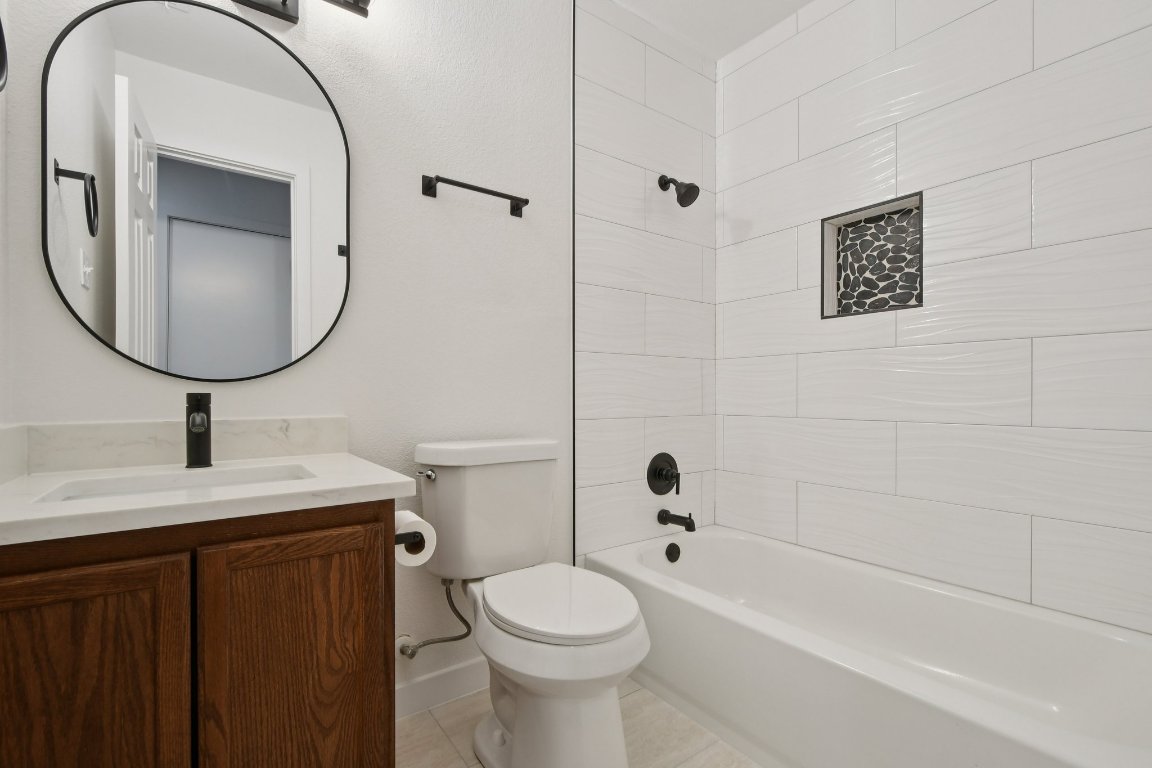 17921 Basket Flower Bend Elgin, TX 78621 - Photo 23 of 40 a bathroom with a sink a toilet and a mirror