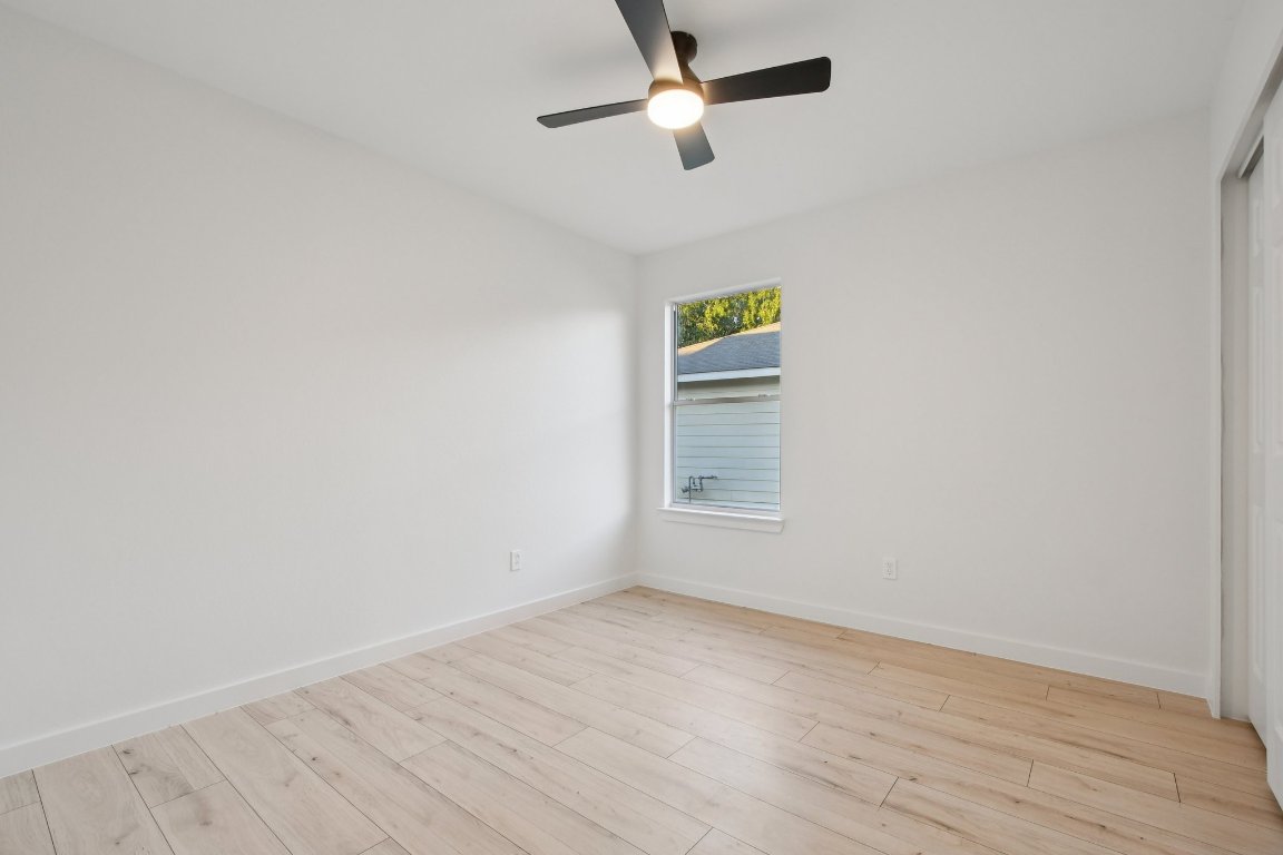 17921 Basket Flower Bend Elgin, TX 78621 - Photo 25 of 40 a view of empty room with wooden floor and fan