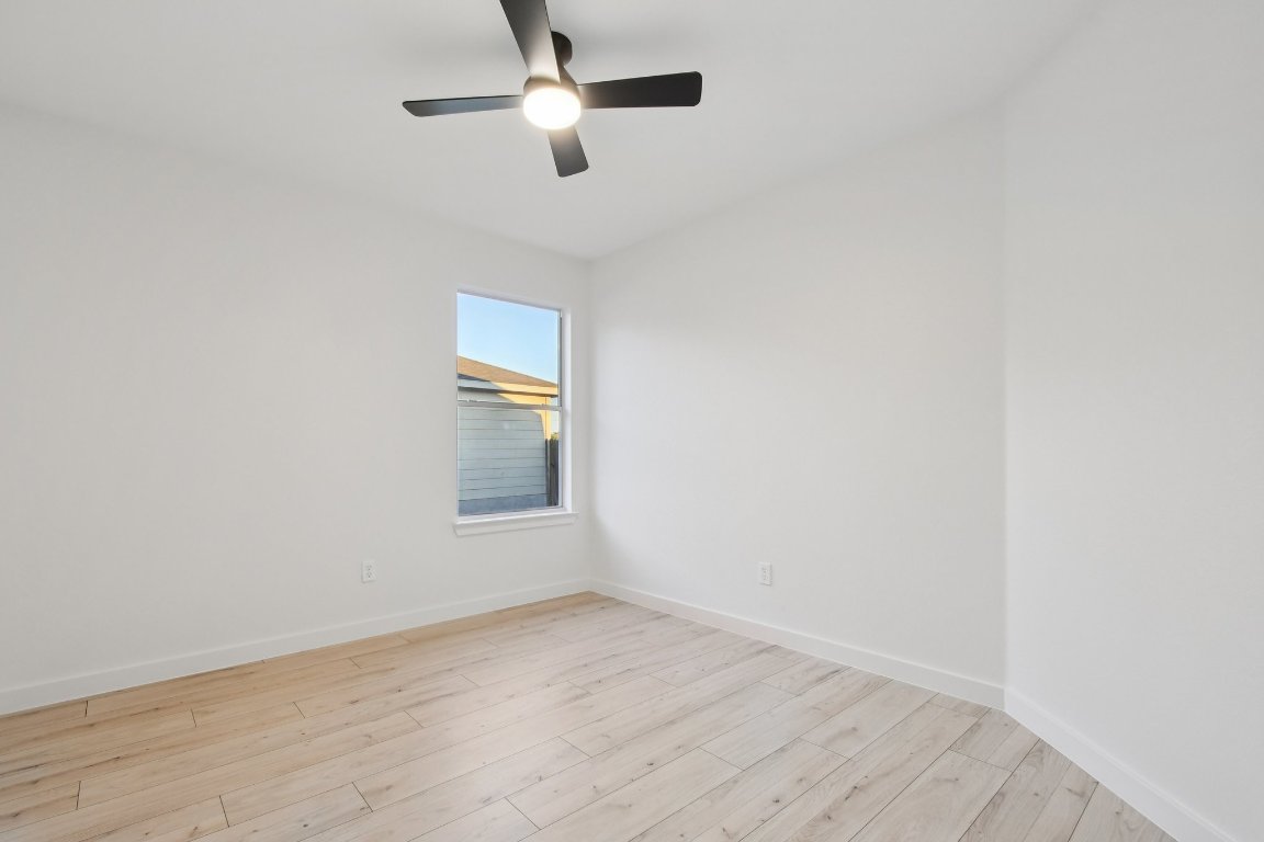 17921 Basket Flower Bend Elgin, TX 78621 - Photo 28 of 40 an empty room with a window and ceiling fan