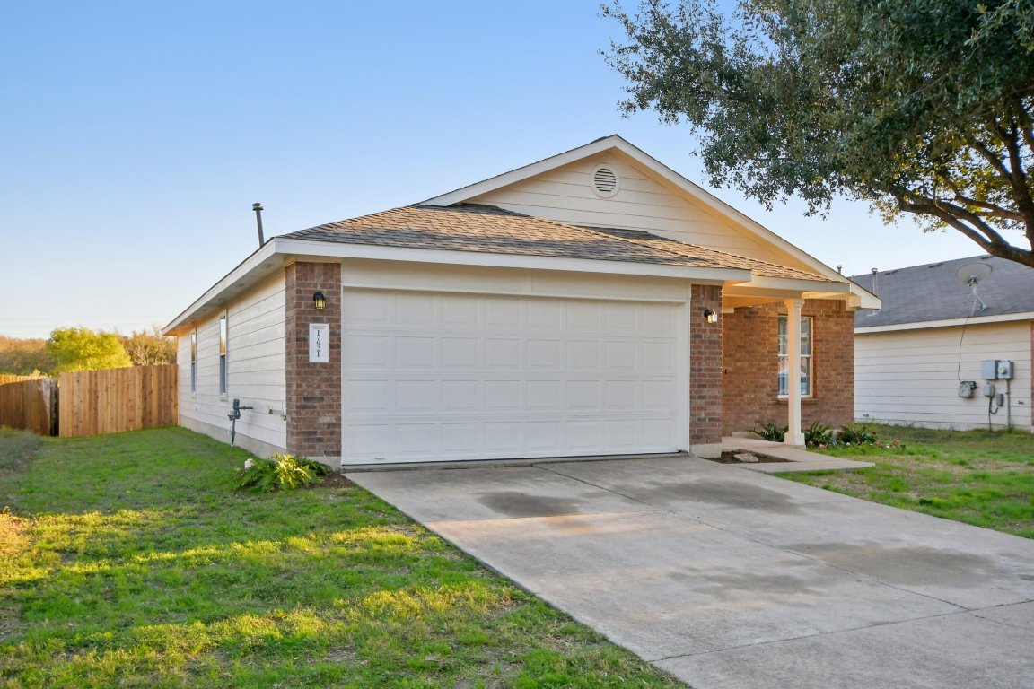 17921 Basket Flower Bend Elgin, TX 78621 - Photo 3 of 40 a front view of a house with a yard and garage