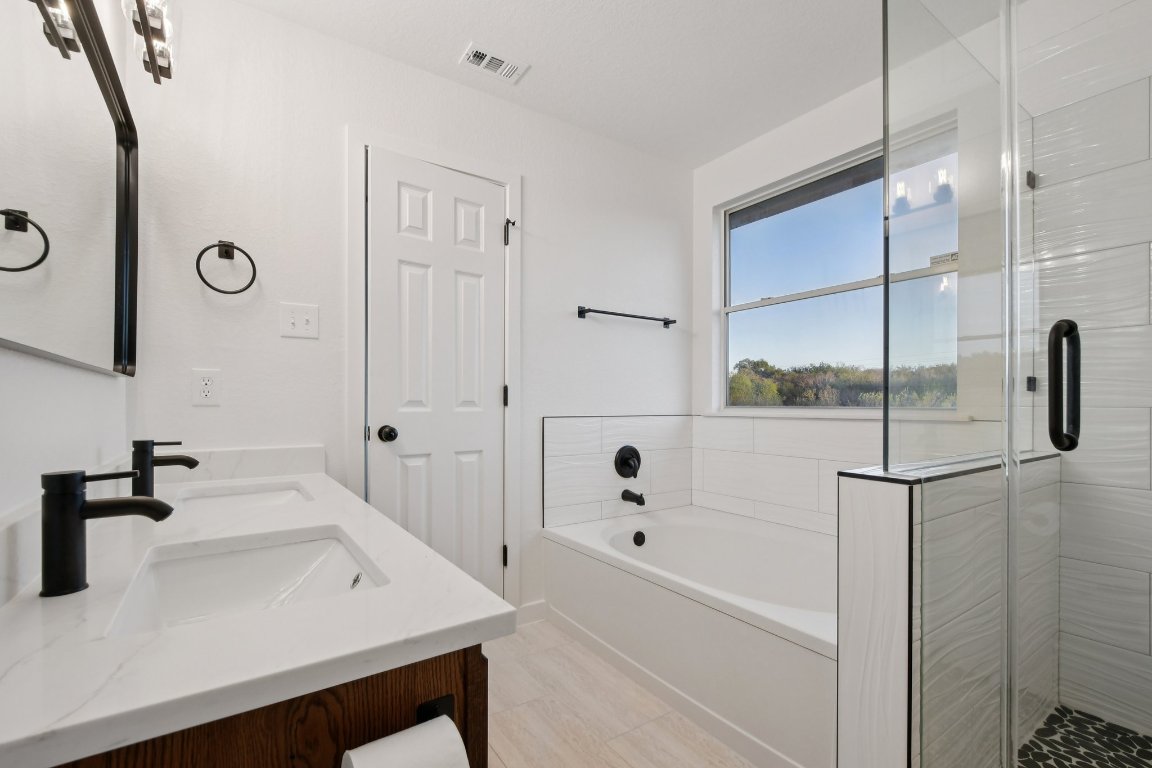 17921 Basket Flower Bend Elgin, TX 78621 - Photo 38 of 40 a bathroom with a bathtub and a sink