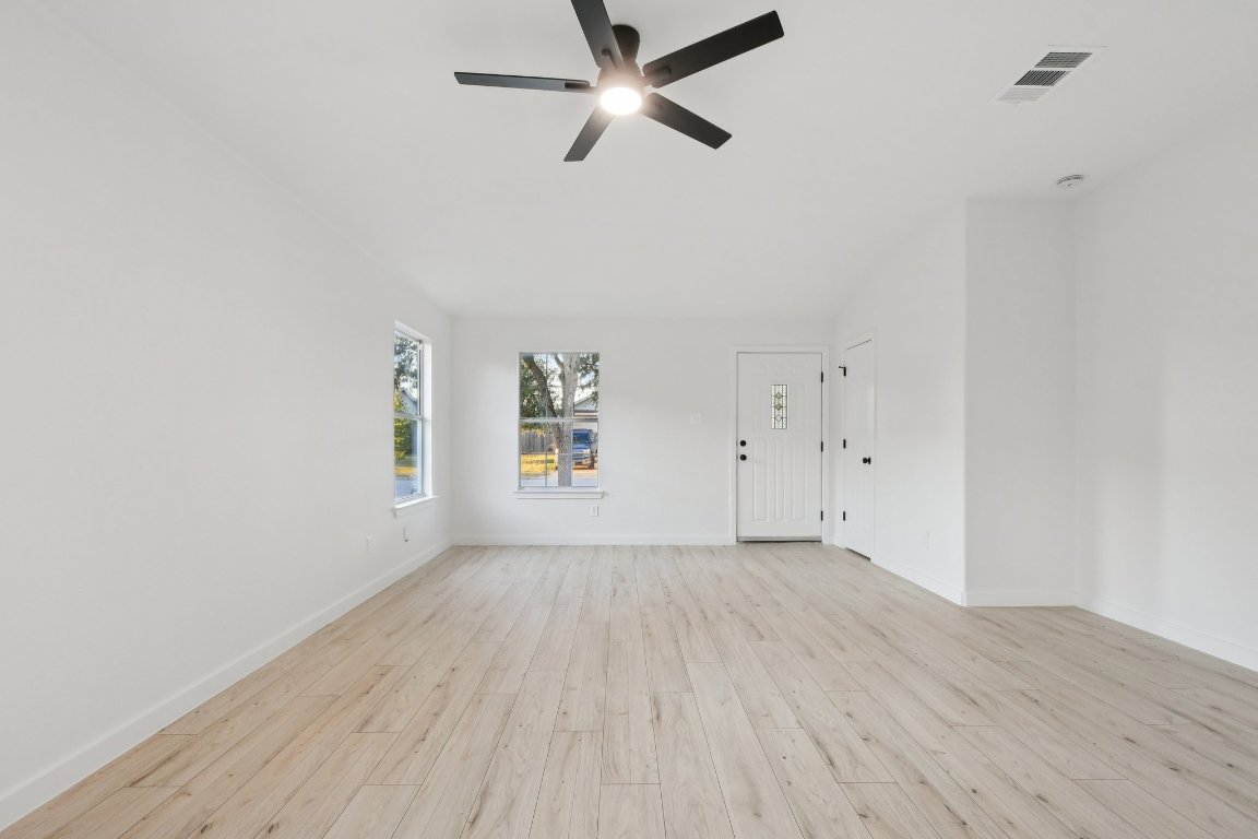 17921 Basket Flower Bend Elgin, TX 78621 - Photo 5 of 40 an empty room with a window and ceiling fan