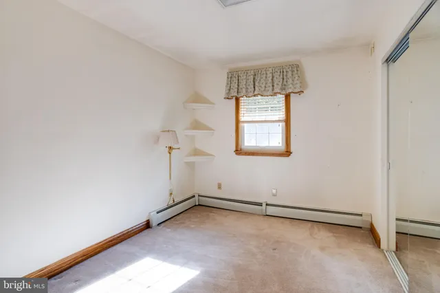 a view of a house with a big yard and large trees