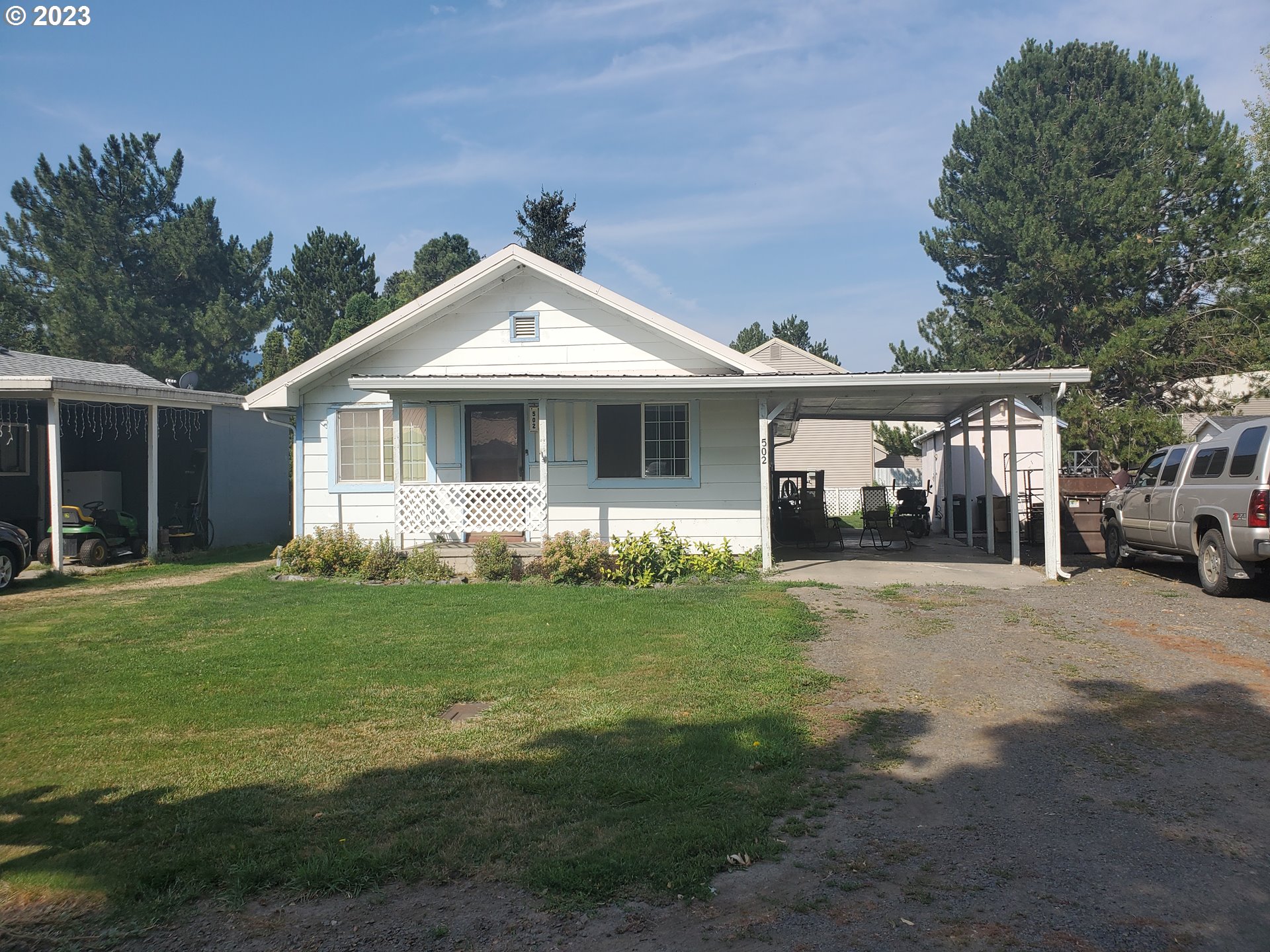a front view of a house with a garden