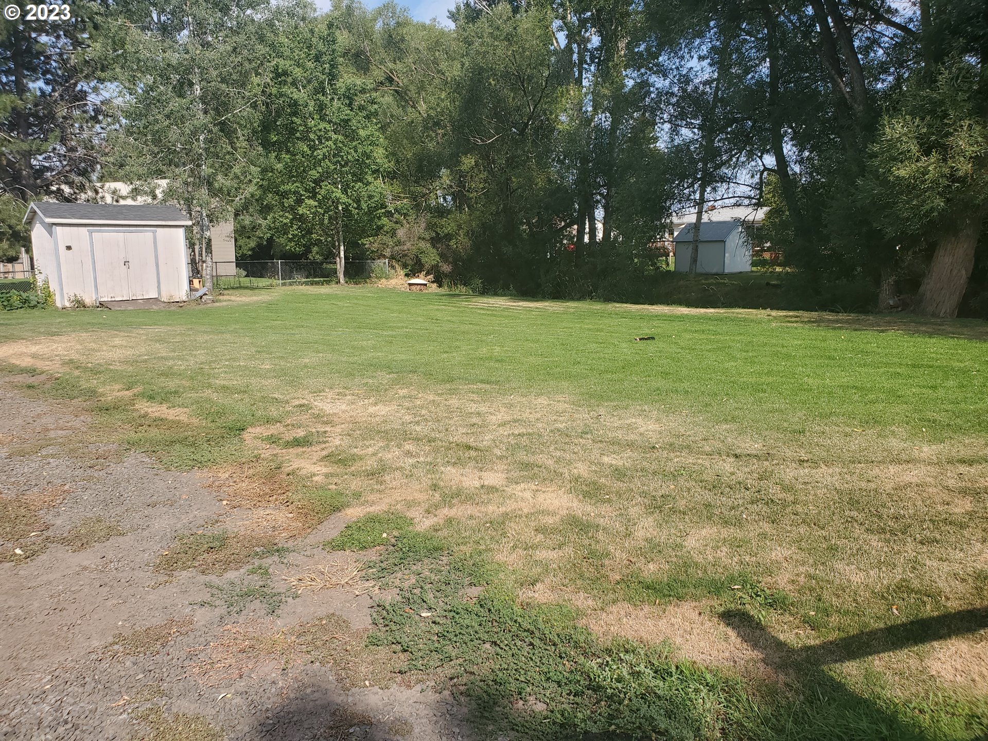 502 Southeast Evans Lane Enterprise, OR 97828 - Photo 7 of 18 a view of a field with trees in the background