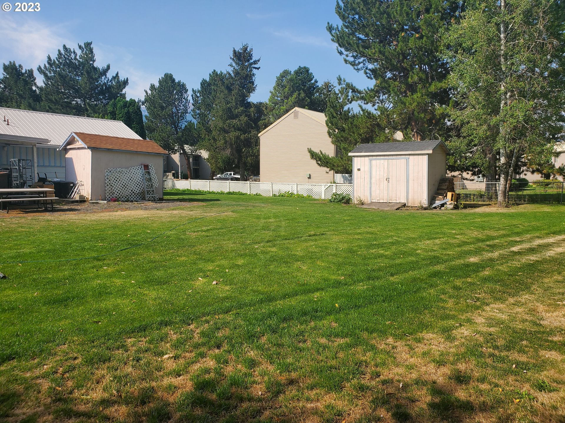 502 Southeast Evans Lane Enterprise, OR 97828 - Photo 8 of 18 a front view of a house with a garden and trees