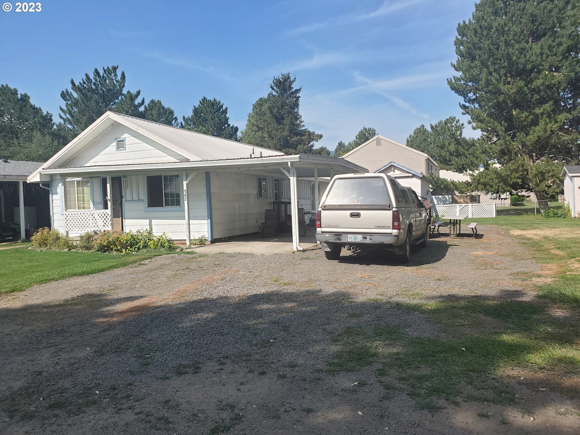 502 Southeast Evans Lane Enterprise, OR 97828 - Photo 10 of 18 a car parked in front of white house