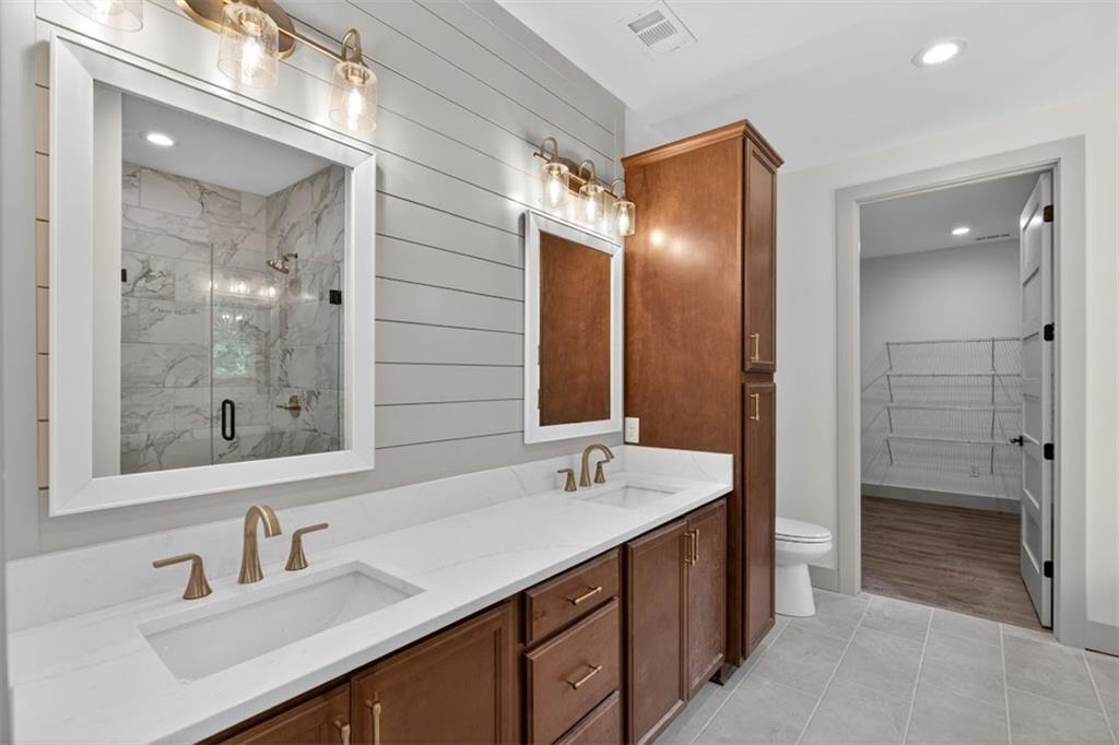 1416 Morgan Road Bremen, GA 30110 - Photo 10 of 32 a bathroom with a double vanity sink mirror and shower