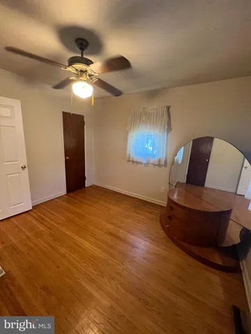 a bedroom with a bed and ceiling fan