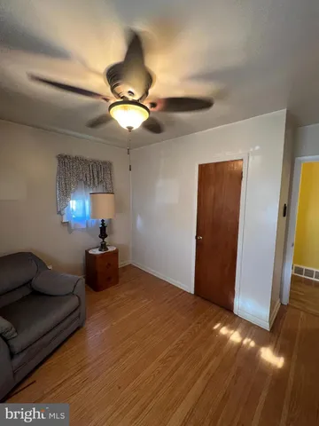a view of a livingroom with furniture and chandelier fan
