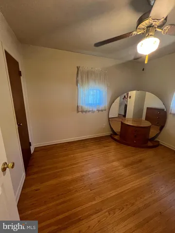 a view of a room with wooden floor and potted plant
