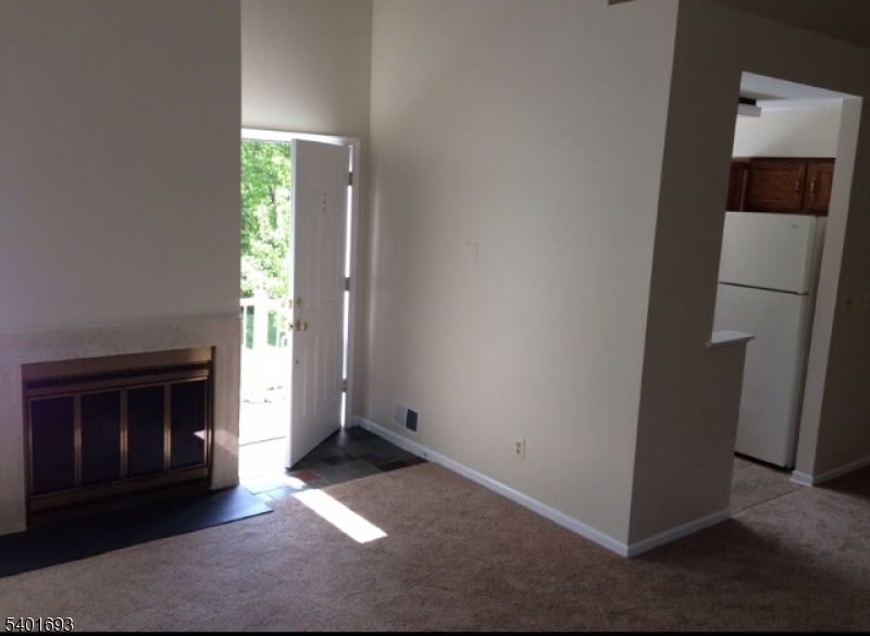 16 Stevens Court Bedminster, NJ 07921 - Photo 4 of 9 an empty room with windows and fireplace