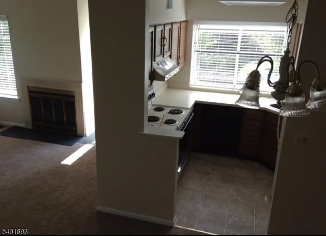 a kitchen with granite countertop a stove and a microwave