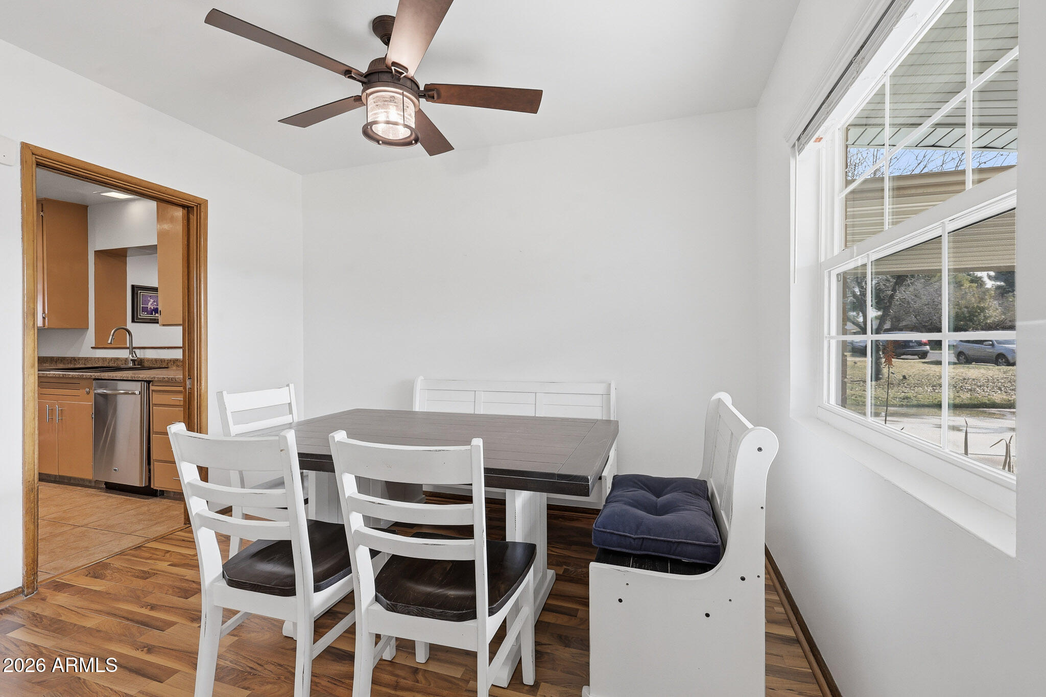 4108 East Edgemont Avenue Phoenix, AZ 85018 - Photo 20 of 118 a view of a dining room with furniture and a chandelier fan