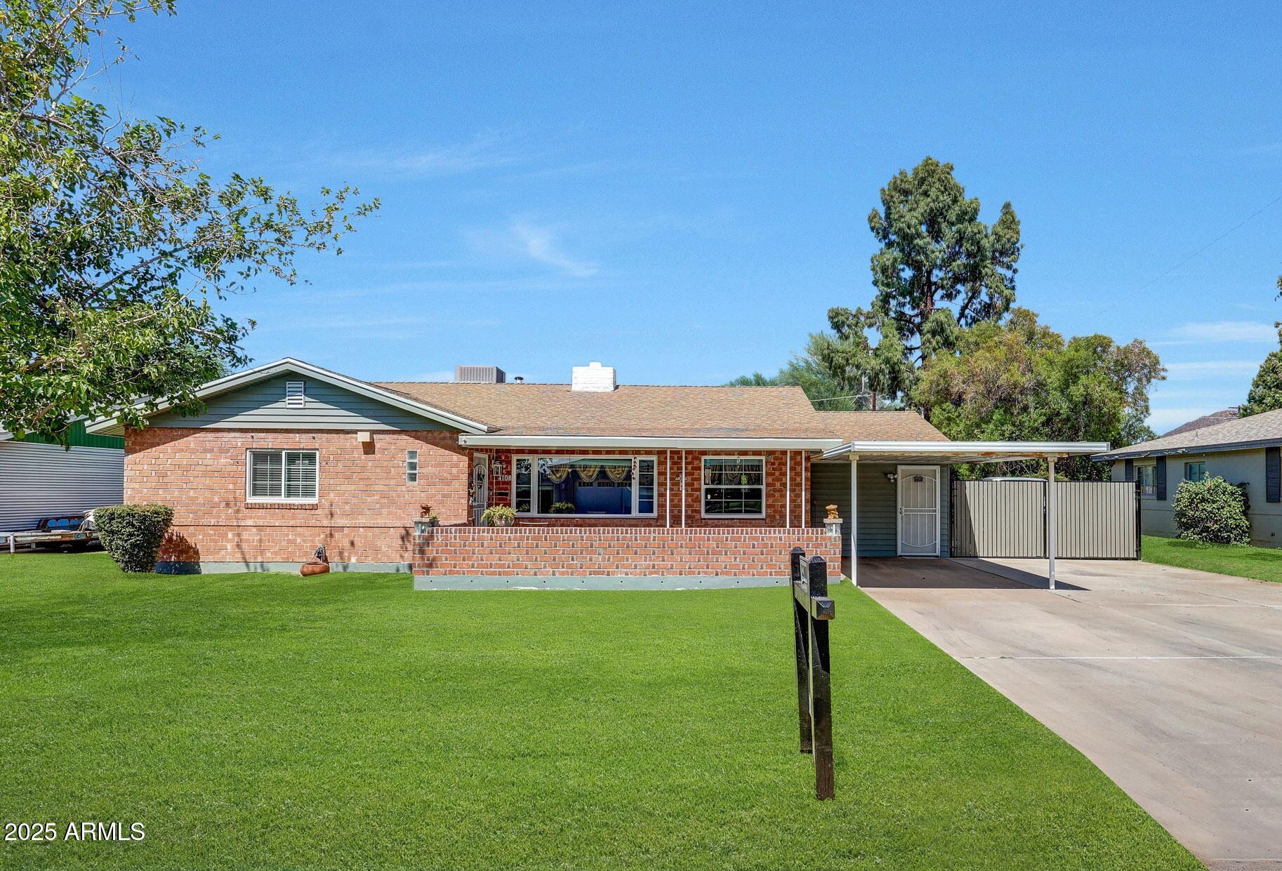 4108 East Edgemont Avenue Phoenix, AZ 85018 - Photo 2 of 118 a view of a house with a yard and a garden