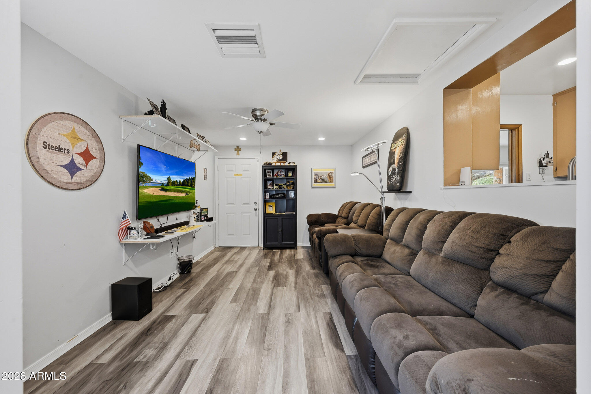 4108 East Edgemont Avenue Phoenix, AZ 85018 - Photo 29 of 118 a living room with furniture a flat screen tv and a wall painting
