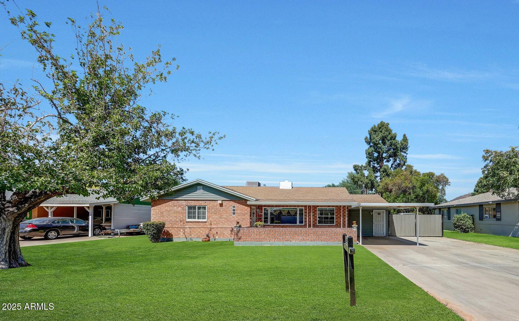 4108 East Edgemont Avenue Phoenix, AZ 85018 - Photo 4 of 118 a front view of a house with a garden