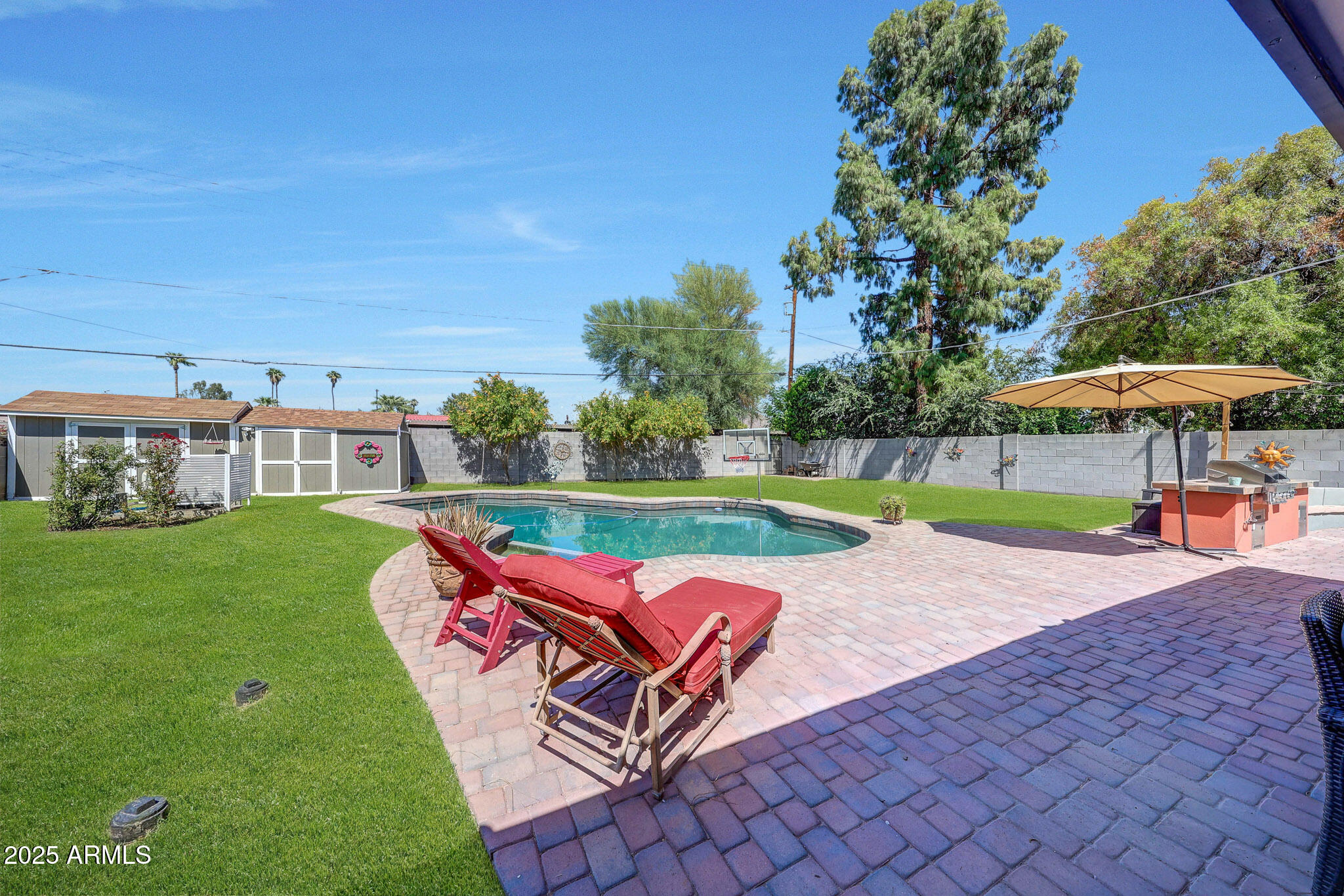 4108 East Edgemont Avenue Phoenix, AZ 85018 - Photo 61 of 118 a view of a swimming pool and lounge chairs in the patio