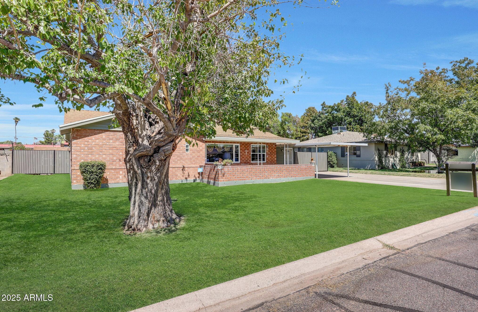 4108 East Edgemont Avenue Phoenix, AZ 85018 - Photo 9 of 118 a front view of a house with a garden