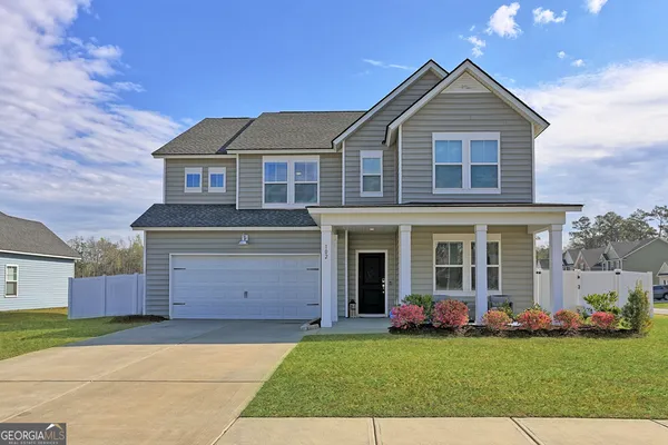 a front view of a house with garden