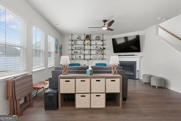 a room with lots of furniture and wooden floors