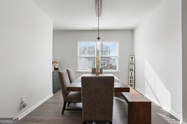 a view of a dining room with furniture window and wooden floor