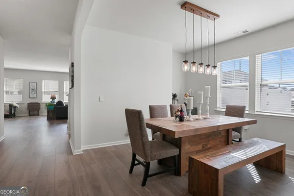 a view of a dining room with furniture window and wooden floor