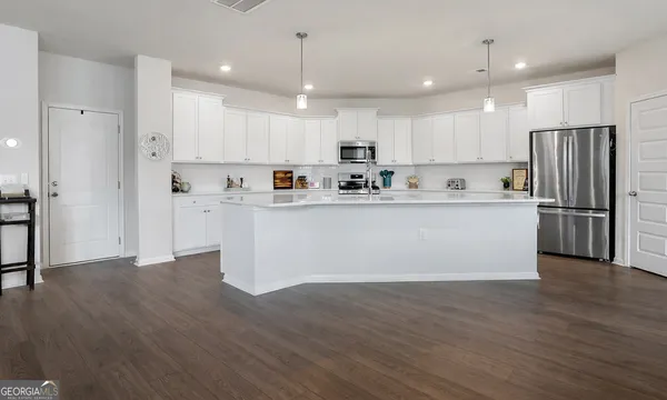a view of kitchen with wooden floor and window