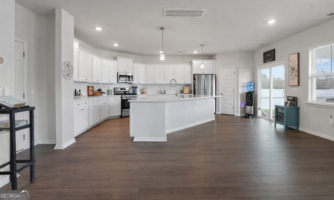 102 Franklins Walk Rincon, GA 31326 - Photo 17 of 51 a large kitchen with cabinets and wooden floor