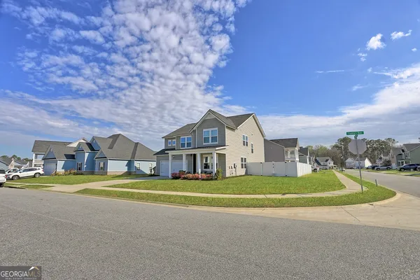 a view of a big room with a big yard and large trees