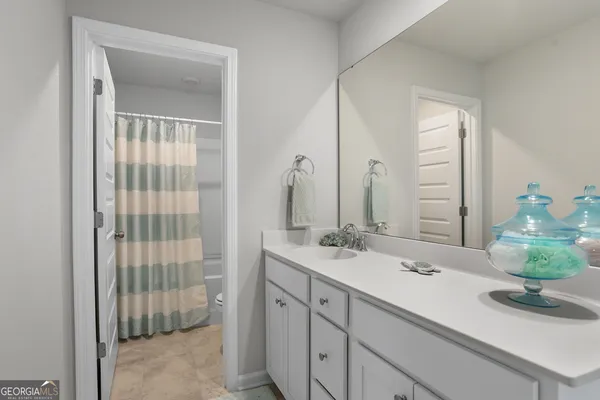 a bathroom with a double vanity sink and a mirror