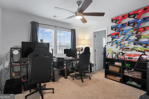 a view of a workspace with furniture and a window