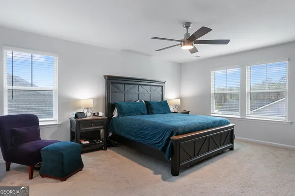 a bed sitting in a bedroom next to a window