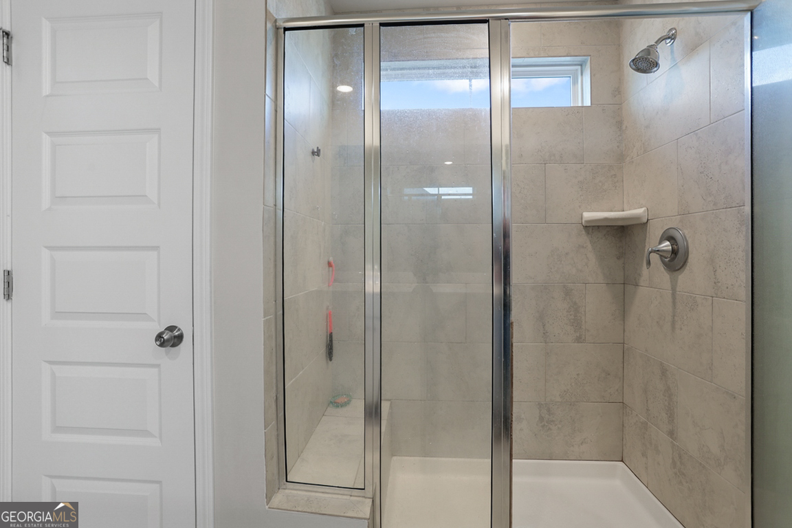 102 Franklins Walk Rincon, GA 31326 - Photo 35 of 51 a bathroom with a glass shower door