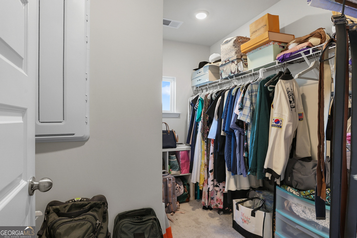 102 Franklins Walk Rincon, GA 31326 - Photo 36 of 51 a view of walk in closet with clothes and shoes