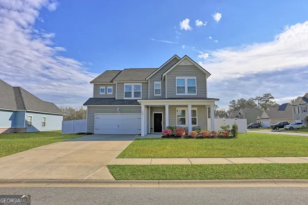 a front view of a house with a yard