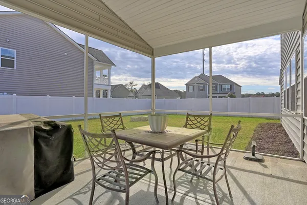 a view of a patio with a table chairs and a table