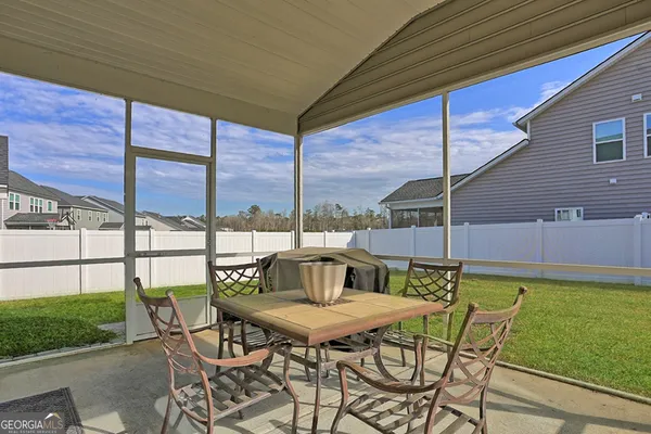 a front view of a house with a garden and yard