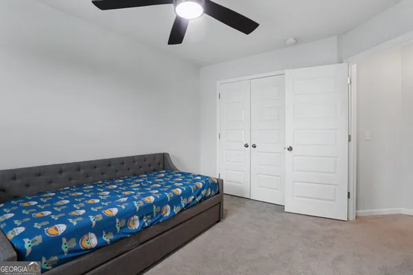 a front view of a house with a garden and yard