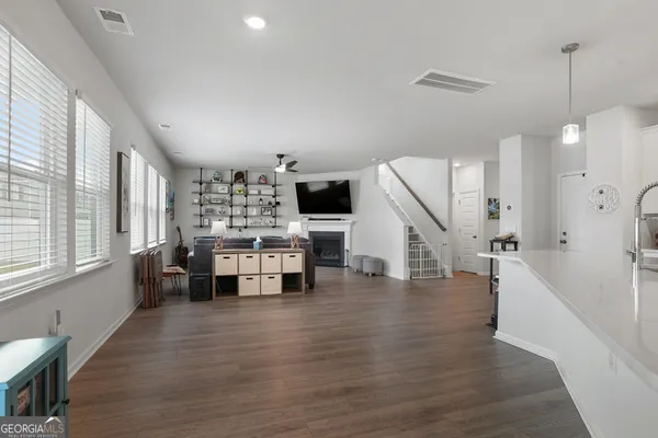 a room with lots of furniture and wooden floors