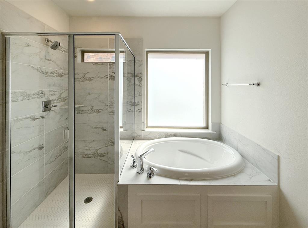 5924 Owen Road McKinney, TX 75071 - Photo 23 of 40 a bathroom with a tub and shower