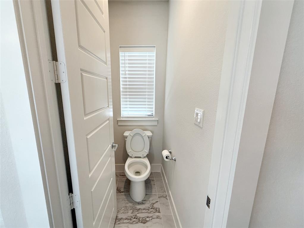 5924 Owen Road McKinney, TX 75071 - Photo 24 of 40 a bathroom with a toilet and a window
