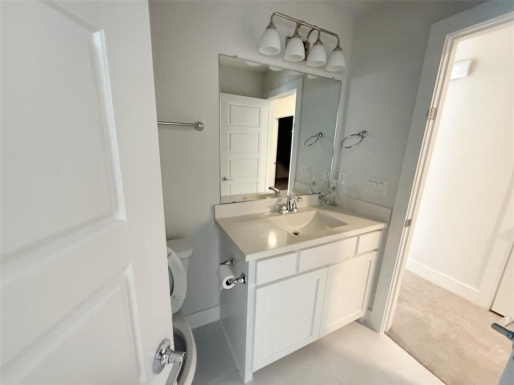 5924 Owen Road McKinney, TX 75071 - Photo 35 of 40 a bathroom with a sink and a mirror