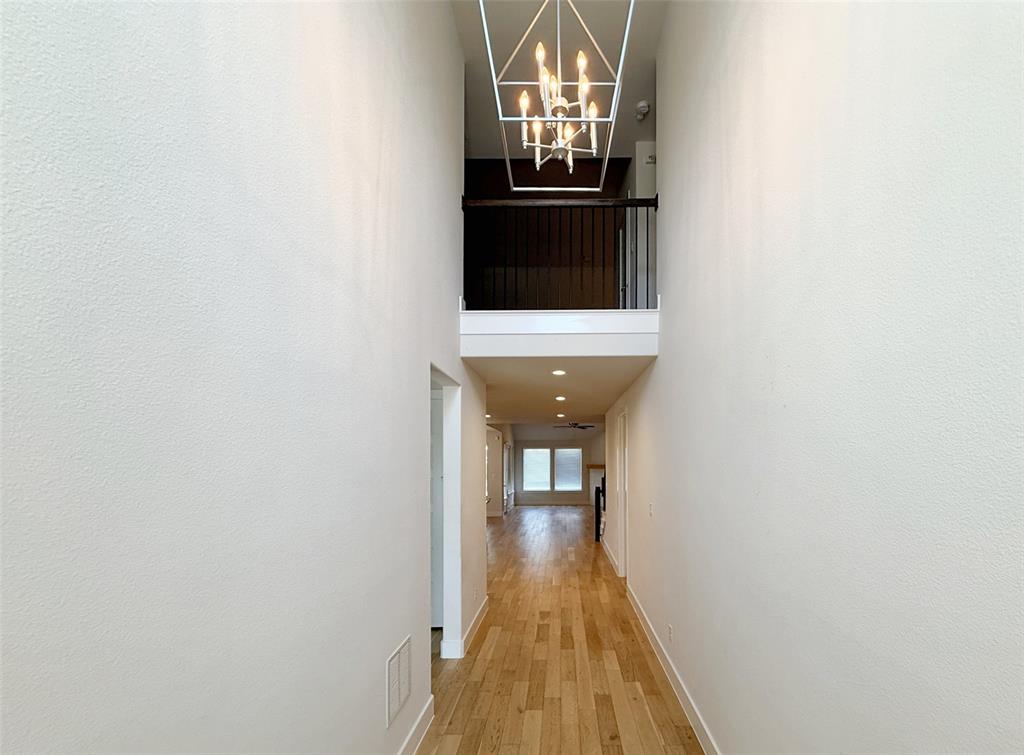 5924 Owen Road McKinney, TX 75071 - Photo 5 of 40 a view of a hallway with wooden floor and staircase
